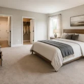 Well-arranged bedroom with a centered bed, dresser, nightstands, and clear walking paths